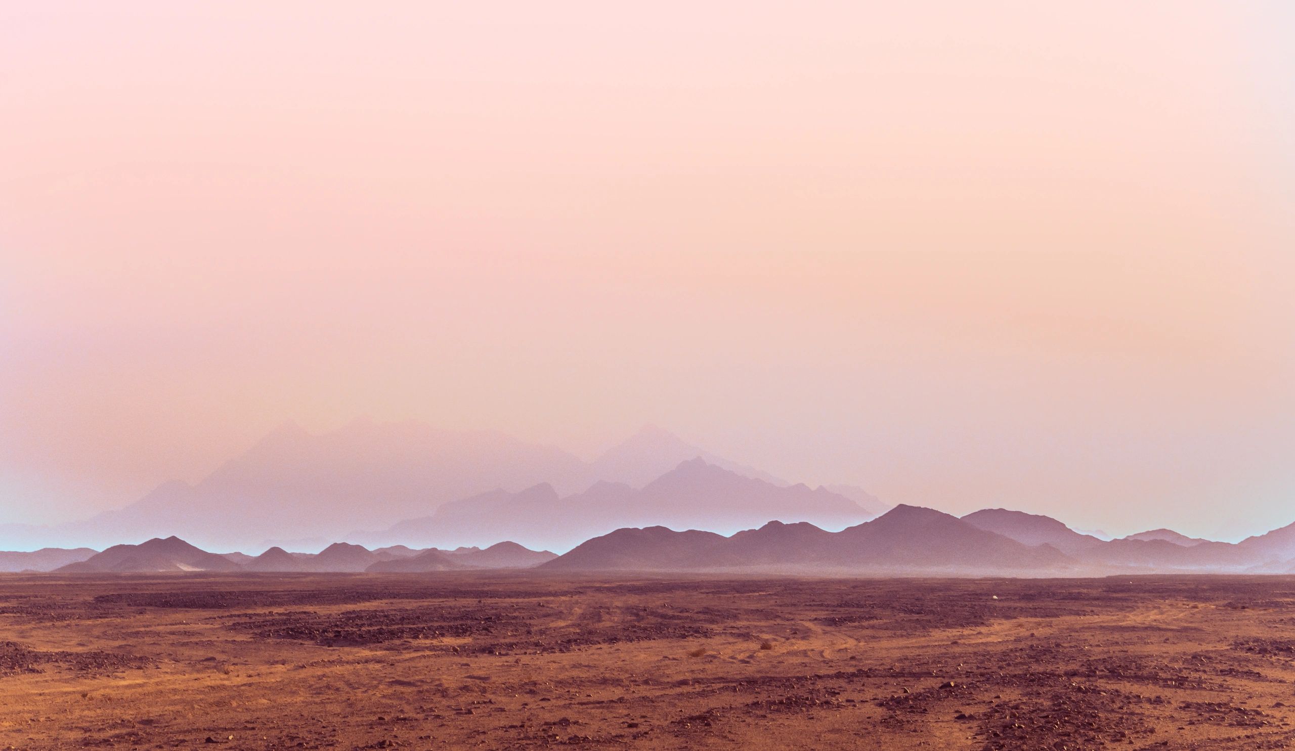 Desert landscape at sunrise with distant hills