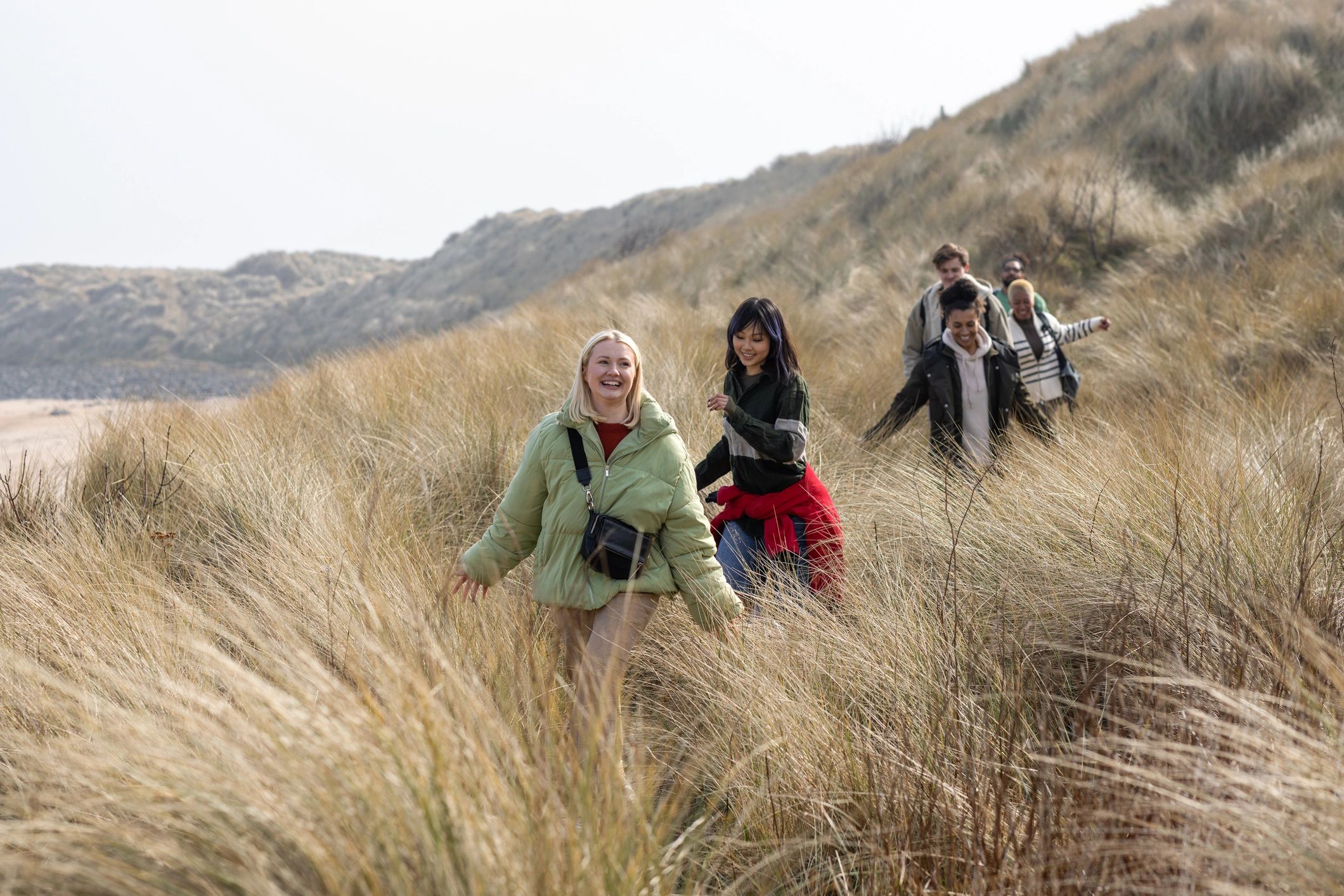 Group of travelers exploring scenic dunes together